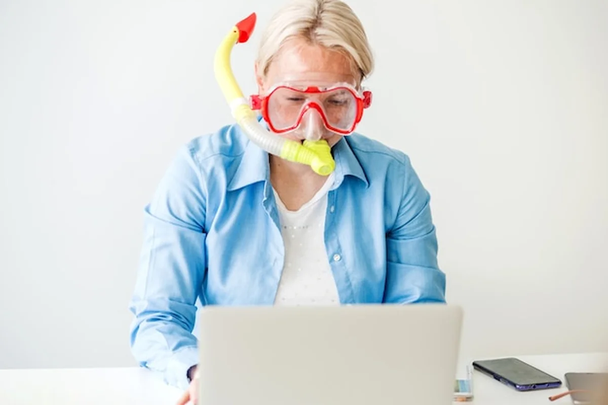 Blondynka w masce do nurkowania siedzi w biurze